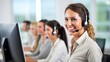 © SOEM - A smiling customer service representative with a headset, seated at a desk in a modern office environment.