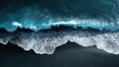 © goodskin - Beach coastline with foamy waves on dark sand