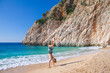 © Tropical studio - Happy boy having fun at Kaputas beach with turquoise sea water, Lycia coast. Summer relaxing day at family vacation in Mediterranean Sea, Kas, Antalya region, Turkey