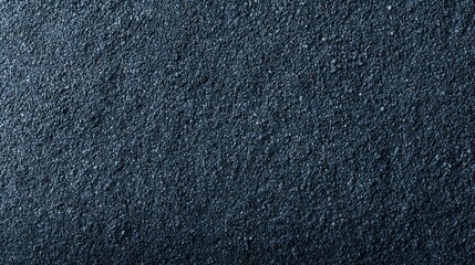 Aufkleber - Fine black sand grains are evenly spread across a surface, with subtle light highlighting their texture and depth, creating soft shadows for visual interest