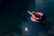 © Parilov - Relaxed Woman in Inner Tube Floating Peacefully on Tranquil River Waters