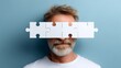 © Gulnaz - A man's face is covered by a puzzle piece, creating a sense of mystery