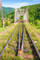 Wall Mural - old railroad passes through the valley. transportation background. mountainous countryside in mornin