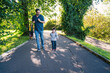 © ADDICTIVE STOCK - Family Stroll in a Sunlit Park on a Pleasant Day