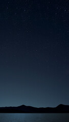 Wall Mural - sunrise over the sea with gentle waves and fading stars in a peaceful, dreamy atmosphere