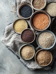 Poster - Whole Grains in Bowls Arranged Artistically on a Cloth Surface, Showcasing a Variety of Textures and Colors in a Natural Setting