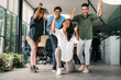 © NDABCREATIVITY - Overjoyed young multiethnic colleagues celebrating shared corporate success or goal achievement