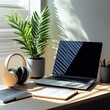 © nucharat - Laptop and Plant on Desk Near Headphones in Bright Sunny Home Office Environment