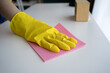 © Andrii Lysenko - female hand in yellow gloves cleaning white table at house. Cleaning and housework