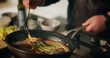 © peopleimages.com - Hands, cooking and chef with pot, meal and preparation for dinner in kitchen, cuisine and restaurant. Catering, employee and person with food for supper, hospitality and skills for gourmet in diner