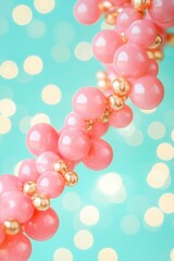 Wall Mural - pink and gold sphere garland on teal bokeh background close up abstract festive decoration party cel