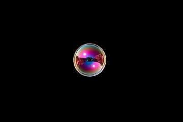 Aufkleber - Colorful bubble reflecting lights in a black background captured in a close-up view