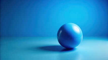 a blue ball lying alone on a bright blue background with a subtle gradient effect