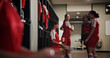 © peopleimages.com - Sport, soccer and women in locker room with coach, preparation for match or break with talking and warm up. Football player, team and people ready for tournament, competition and fitness with chat