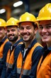 © Artem Zatsepilin - smiling caucasian construction workers wearing yellow hard hats and orange safety vests in line. teamwork and safety in industrial environment. workforce, training, brochure, website poster.