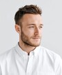 © PooHPiN365 - Stylish Young Man with Beard in White Shirt Looking Away