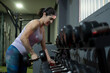 © FotoAndalucia - Woman in gym training with dumbbells