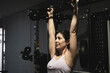© FotoAndalucia - woman training exercises in gym alone, power rack pull-up exercises