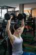 © FotoAndalucia - woman training exercises in gym with weights