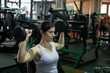 © FotoAndalucia - woman training exercises in gym with weights