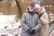 © New Africa - Portrait of happy senior couple at winter park. Space for text