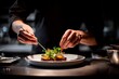 © Віталій Б. - In a chic kitchen, a focused chef delicately garnishes a plated dish with fresh herbs and microgreens, showcasing culinary artistry during evening dinner preparation