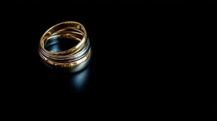 Poster - Glowing gold rings float elegantly against a dark background, showcasing their intricate layers and radiance, while subtle blurs add depth and allure
