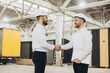© anatoliycherkas - Engineers shaking hands at modular building construction site