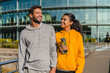 © InsideCreativeHouse - Fitness smiling couple man and woman looking to each others go exercise or running workout and run together. Wellness, sports and health, runner and personal trainer workout in city park