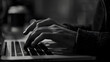 © FANTASY WORLD - Close up of hands typing on a laptop keyboard in a monochrome black and white photograph style