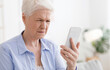 © Prostock-studio - Myopia Concept. Elderly woman squinting while looking at smartphone screen, trying to read message, closeup