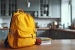 © Hariyanto Bromantio - Yellow backpack and notebooks on a table ready for school season