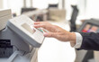 © serhii - businesswoman hand on printer button
