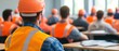 © Duskcraft - Back View of Construction Workers Attending Safety Training Seminar in Brightly Lit Classroom Environment with Desks