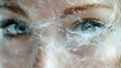 © Phoneutria - Ephemeral Beauty: Close-up view of a woman's face, her eye framed by a delicate web of frosty textures, evoking a sense of enchantment and fragility.