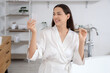 © Pixel-Shot - Young woman with oral contraceptive pills in bathroom