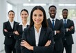 © Laki - Smiling diverse business team in suits stands with arms crossed in office