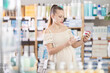 © JackF - Watchful pregnant female client trying to choose paracetamol in chemist's shop