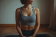 © Centric  - Young woman sitting on the floor of her home, dressed in sportswear, meditating and embracing a moment of relaxation and tranquility