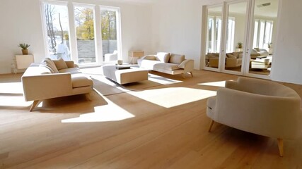 Aufkleber - Bright and airy living room features comfortable seating arrangements, large windows allowing sunlight to stream in, and a warm wooden floor. The modern decor complements the inviting atmosphere.