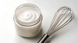 © Shepoupung - Vegan baking Whipped vegan cream in glass jar with metal whisk for baking on white surface creating smooth texture