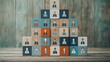 © kipli - Stacked blocks form a pyramid, each showing a diverse person icon, symbolizing team