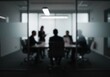 © Vooglo.com - Silhouetted figures gather for a business meeting in a modern office conference room