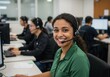 © Vooglo.com - Smiling woman wearing headset works at computer in a busy call center environment