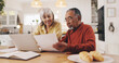 © peopleimages.com - Elderly couple, documents and finance in home for results, laptop or smile with goal for pension. Interracial relationship, man and woman for investing, happy or profit for retirement income in house