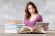 © Phongsri - High school student studying with open books and tablet on a wooden desk,