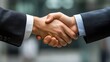 © NCSF - Business Handshake in Office Setting, Close-up of two people shaking hands in a warmly lit office setting, symbolizing agreement or partnership