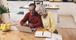 © peopleimages.com - Elderly couple, laptop and finance in home with documents, results or smile with goal for pension. Interracial relationship, man and woman for investing, happy or email for retirement income in house
