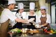 © Prathankarnpap - Culinary students peel and organize onions during a hands on cooking class