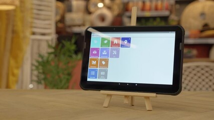 dolly shot of a smart tablet showing a display with many buttons within an app